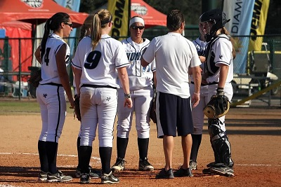 Softball players in a huddle
